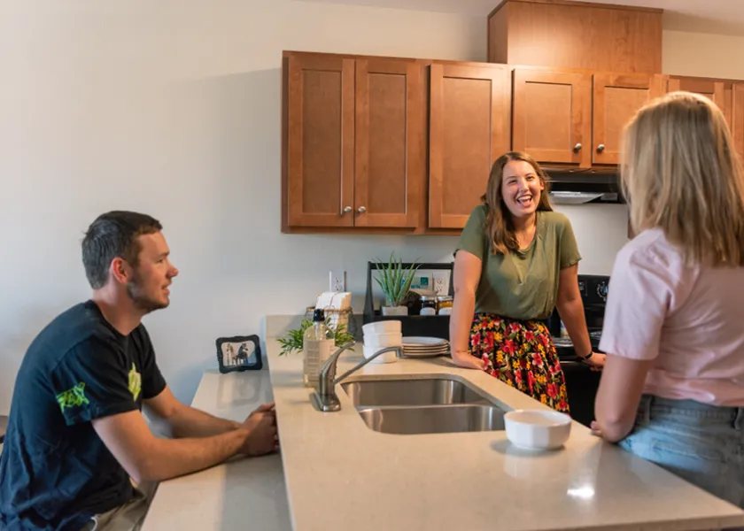 Three students in the apartment Kitchen