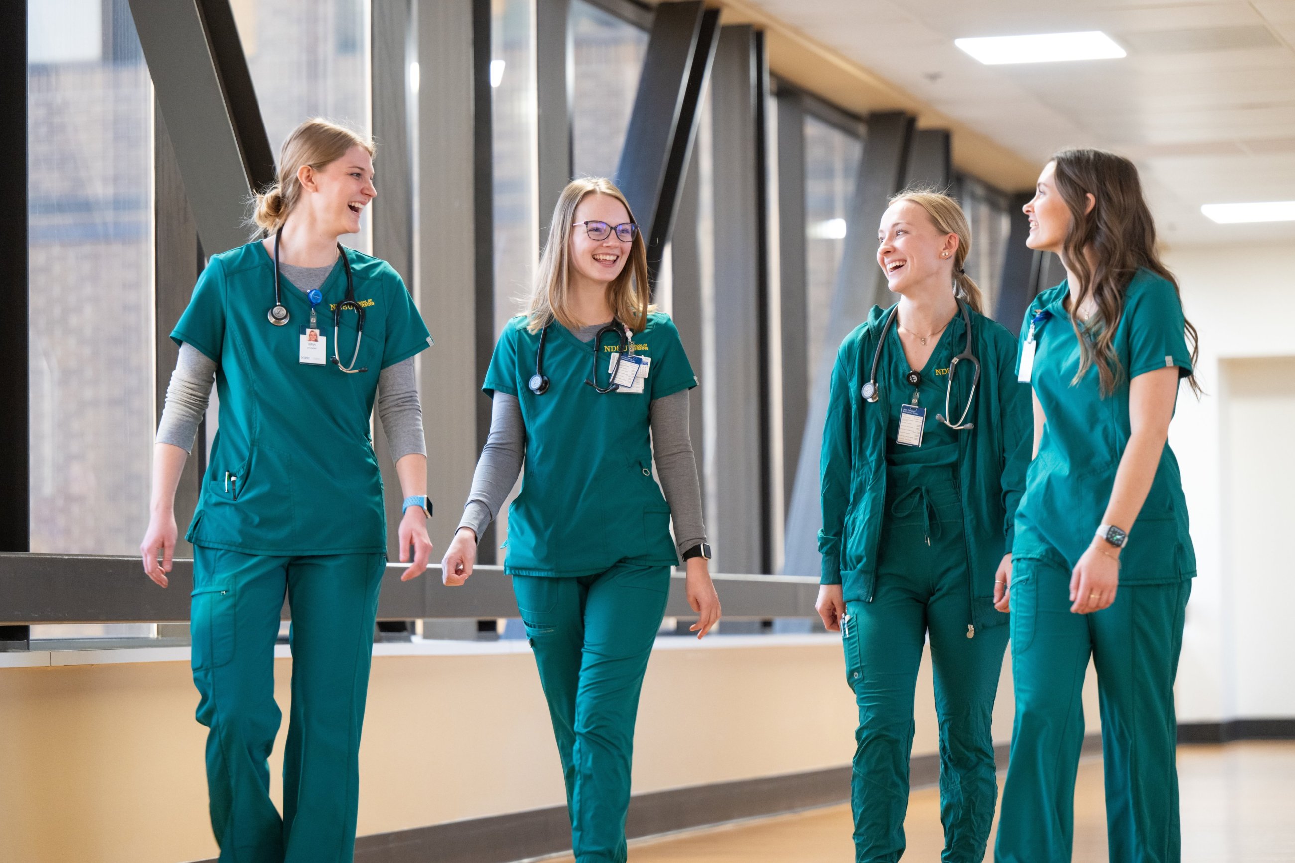 A photo of four student nurses walking together at the School of Nursing at Sanford Health in Bismarck.